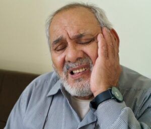 An old man suffering from gums peeling needs immediate treatment in Scottsdale, AZ. 