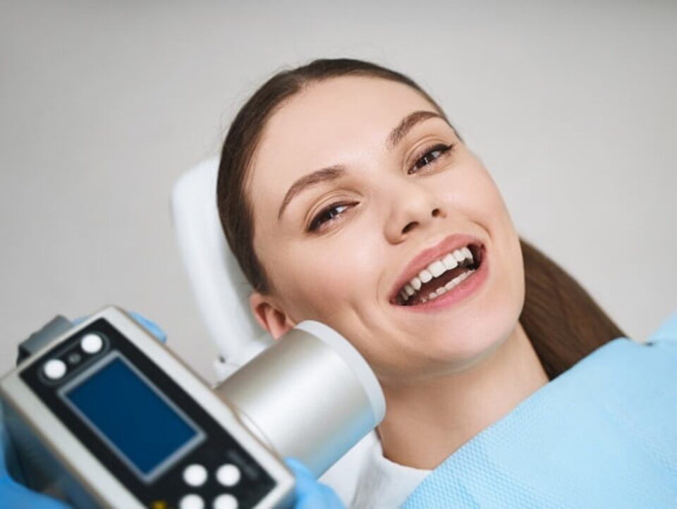 A person smiling while receiving an oral xray