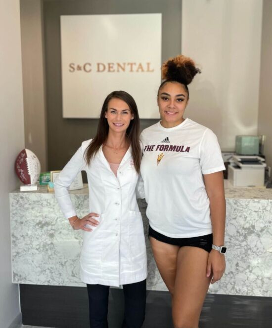 Dentist and female athlete patient smiling after dental treatment in Scottsdale, AZ