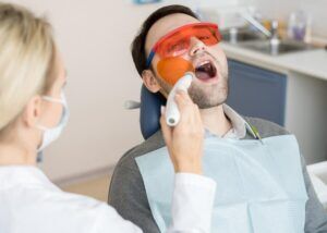 A doctor is providing laser gum treatment to a patient in Scottsdale, AZ
