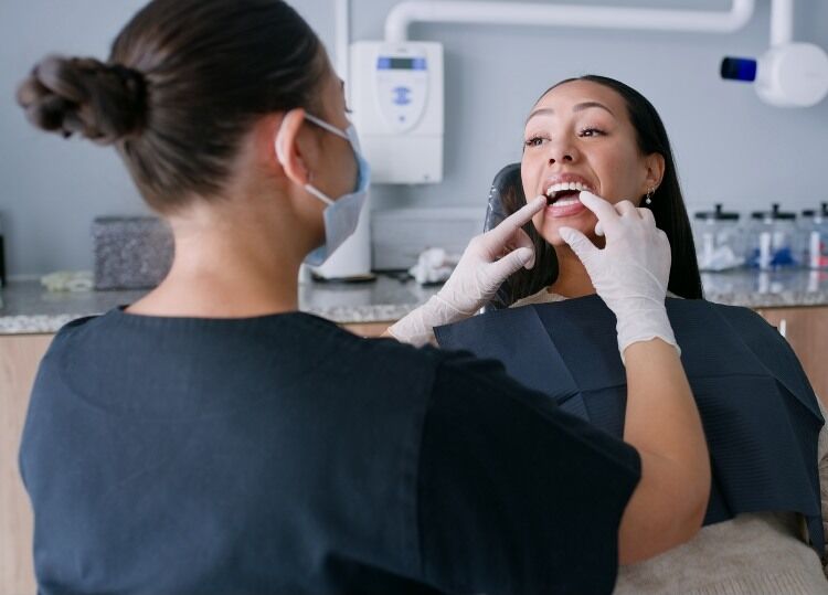Dentist performing Oral screening on a patient