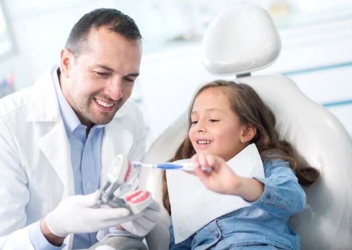 Pediatric dentist treating a child - S&C Dental