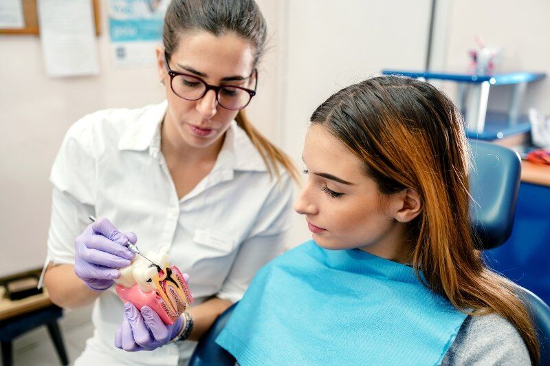 Dentist discussing periodontal treatment with patient