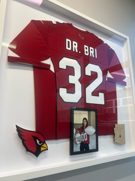Frame of Dr. Bri with AZ Cardinals Jersey and Helmet in Scottsdale, AZ - S&C Dental