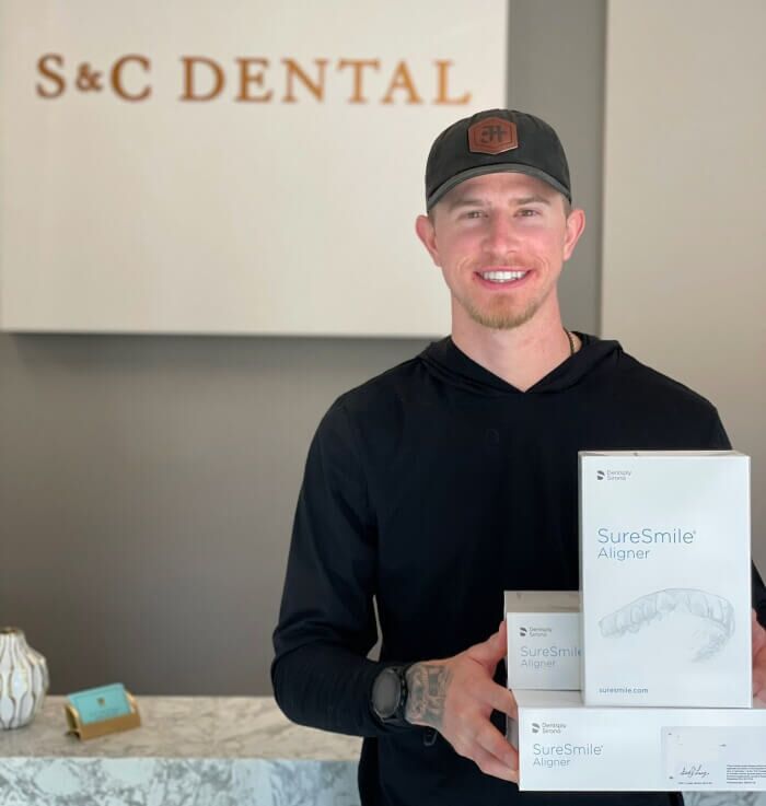 A man displays a box of Dental aligners for patients in Scottsdale, AZ