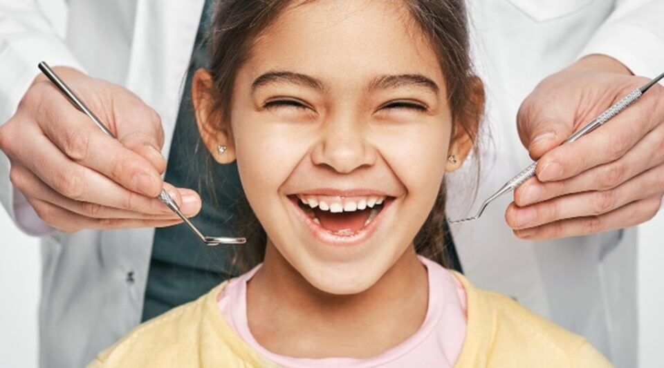 A child smiling at the dentist office